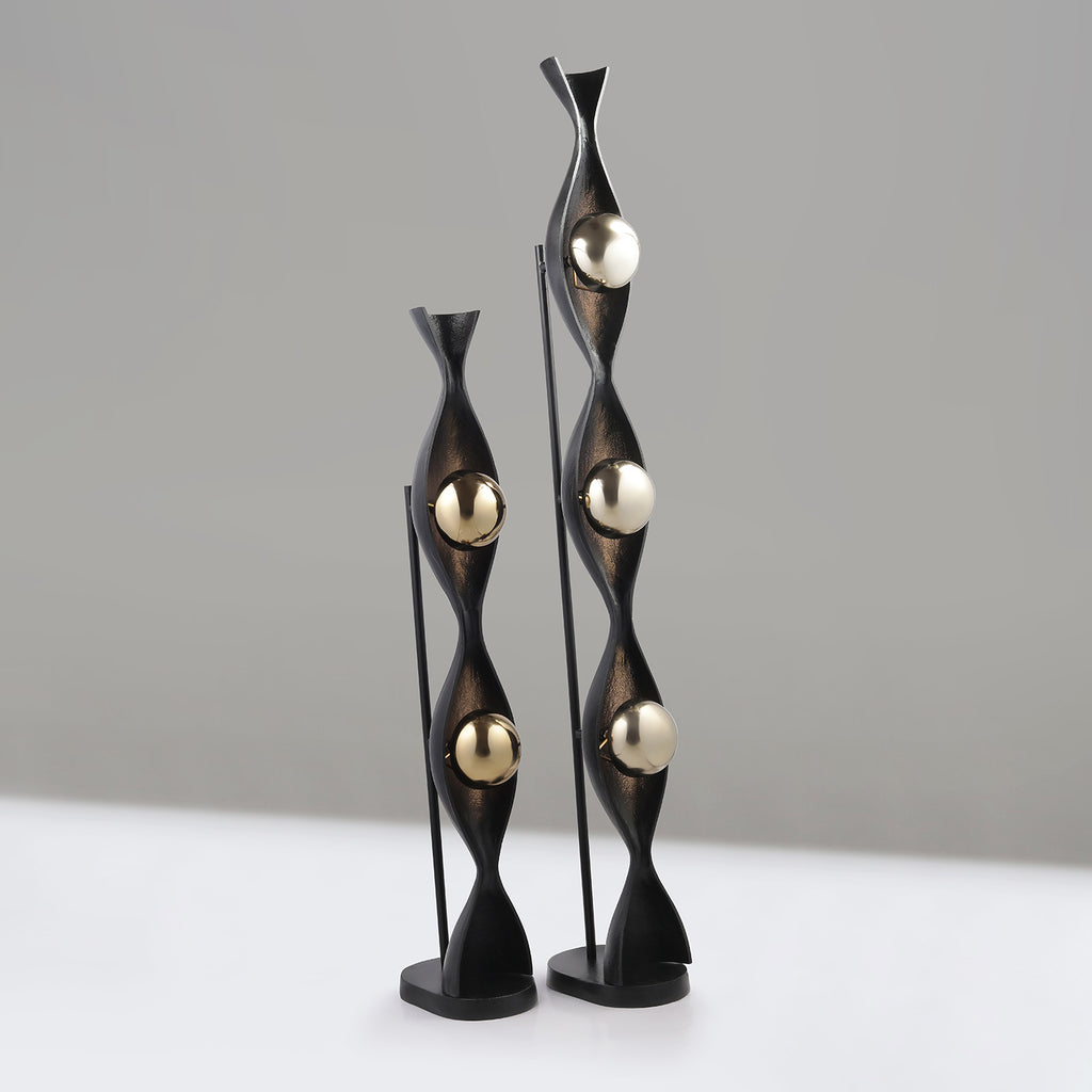Decorative floor lamps with black and gold design on a neutral background