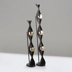 Decorative floor lamps with black and gold design on a neutral background