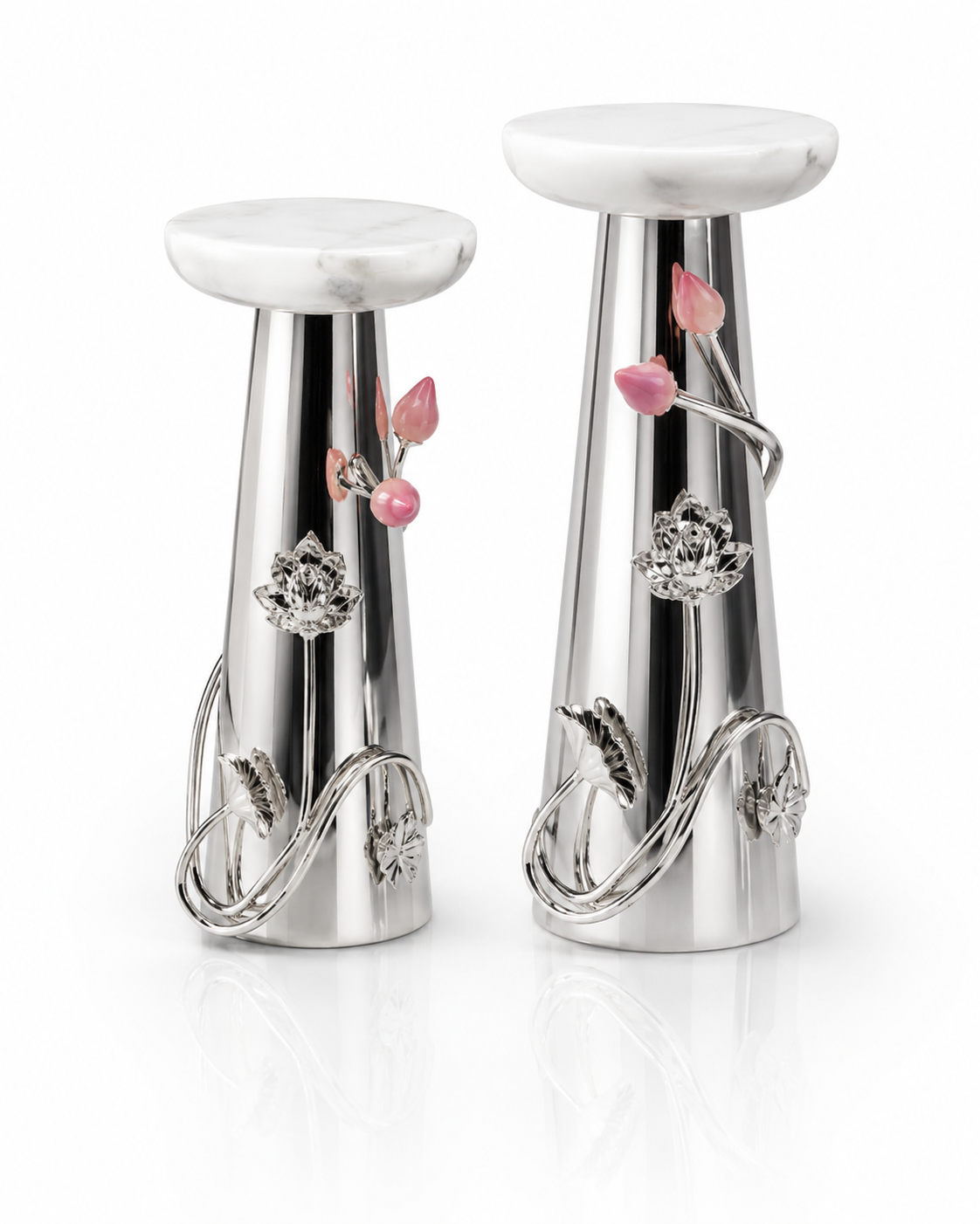 A pair of silver-toned decorative pedestal stands with white marble-look round tops, featuring pink floral accents and clear crystal-like flower details on a clean white background.