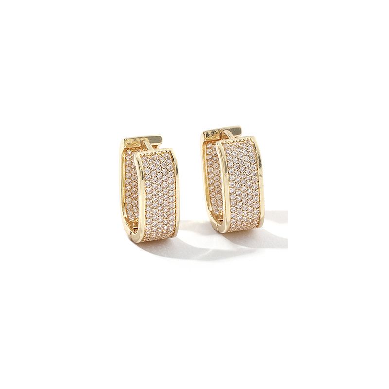 Gold hoop earrings with embedded stones on a white background
