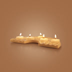 Marble candle holder with four lit candles on a brown background
