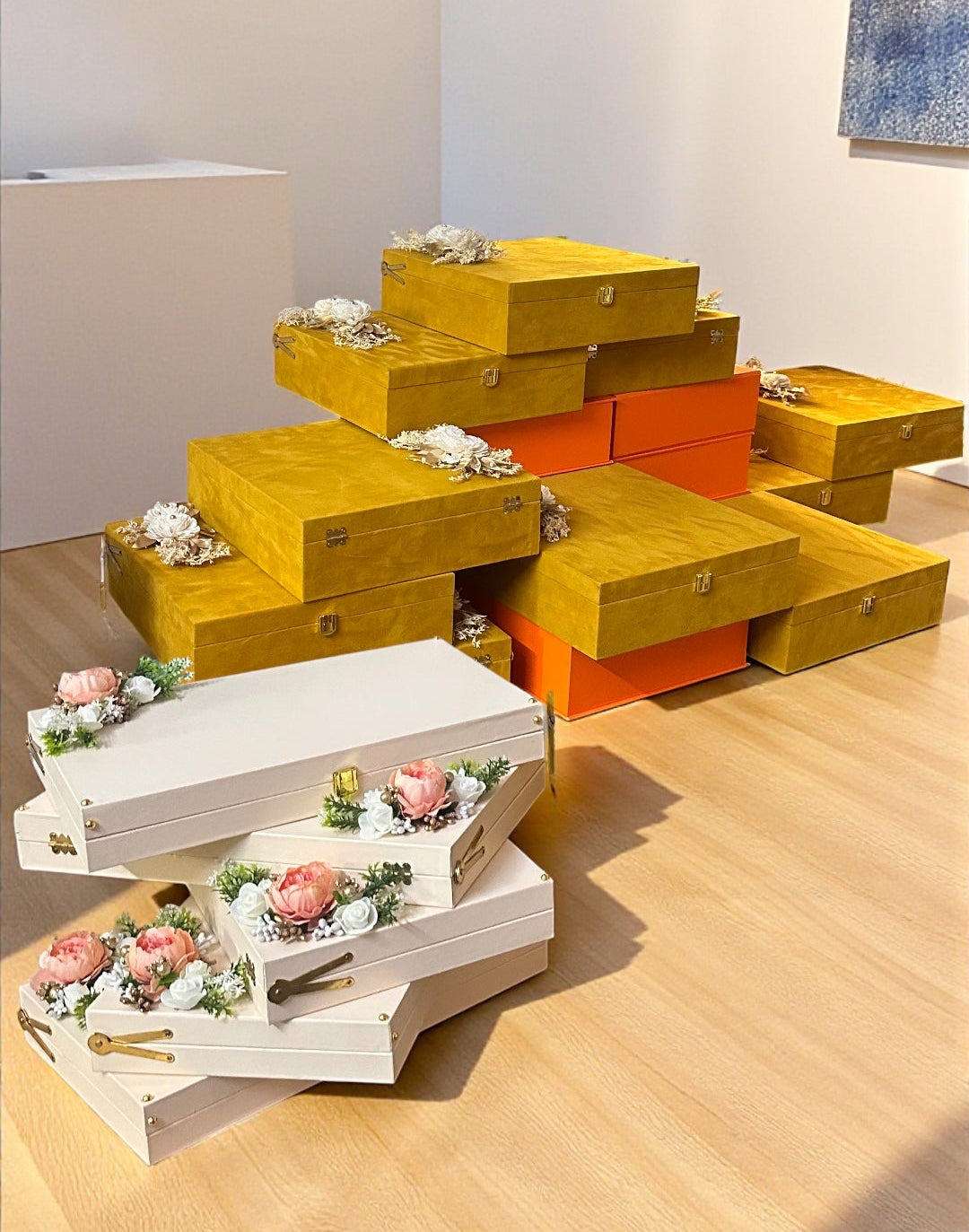 Colorful shoe boxes arranged in a pyramid formation on a wooden floor.
