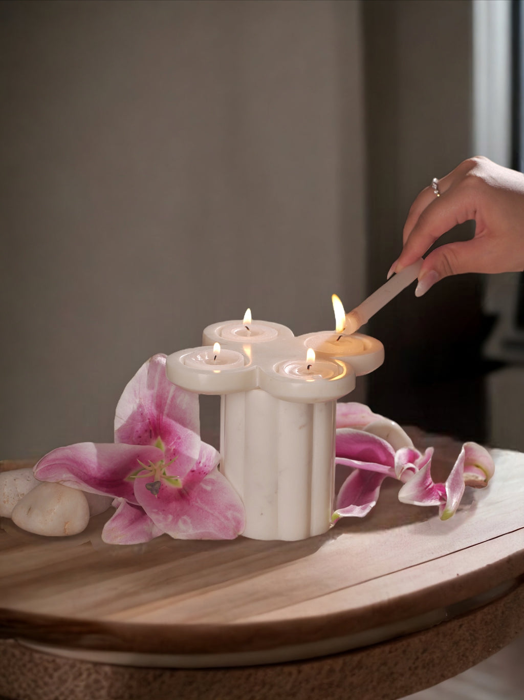Tea light holder with flowers placed around 