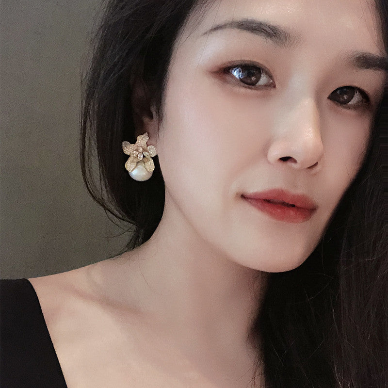 Close-up of a woman wearing a floral earring 