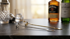 Bar tools and liquor bottles on a bar counter
