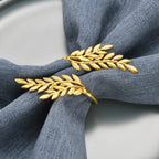 Gold leaf-shaped napkin ring on a gray napkin