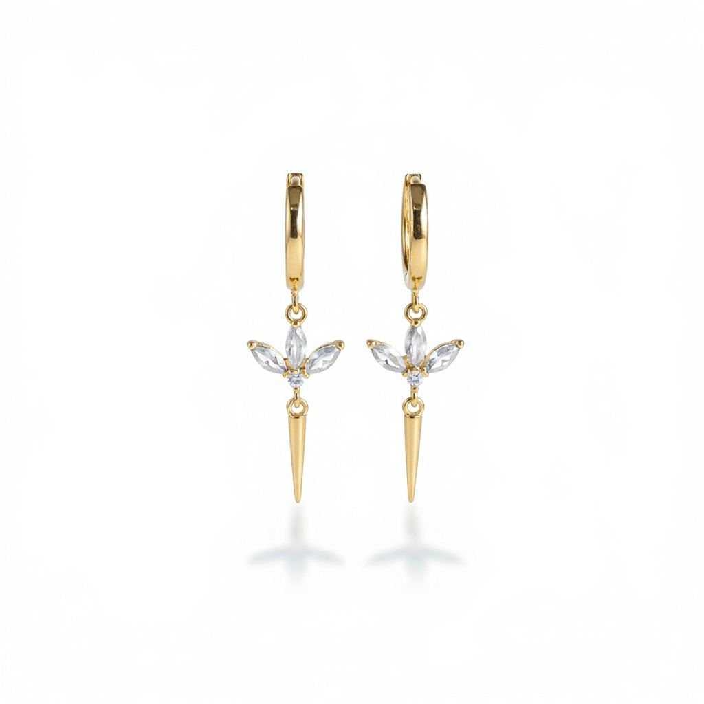 Gold hoop earrings with spike and gemstone designs on a white background