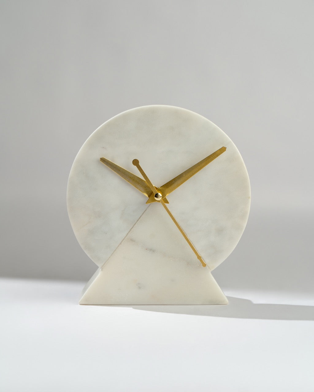 Marble clock with gold hands on a white background