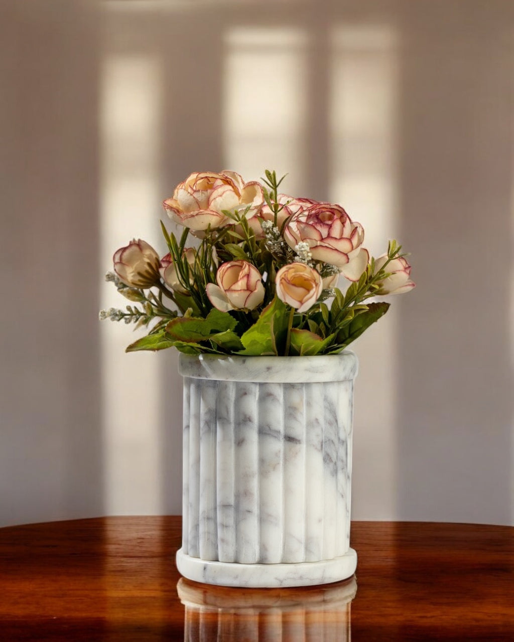 Marble-patterned vase with a bouquet of flowers on a wooden surface