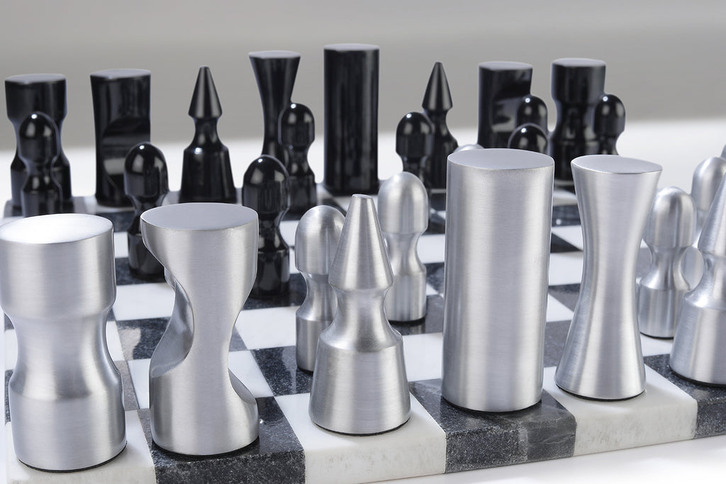 Metallic chess pieces on a checkered chessboard