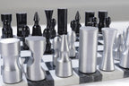 Metallic chess pieces on a checkered chessboard