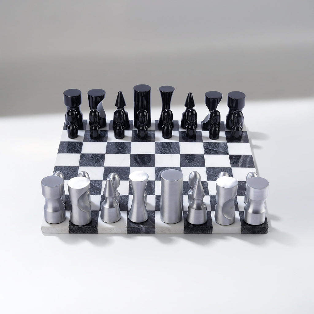 Black and silver chess set on a checkered board