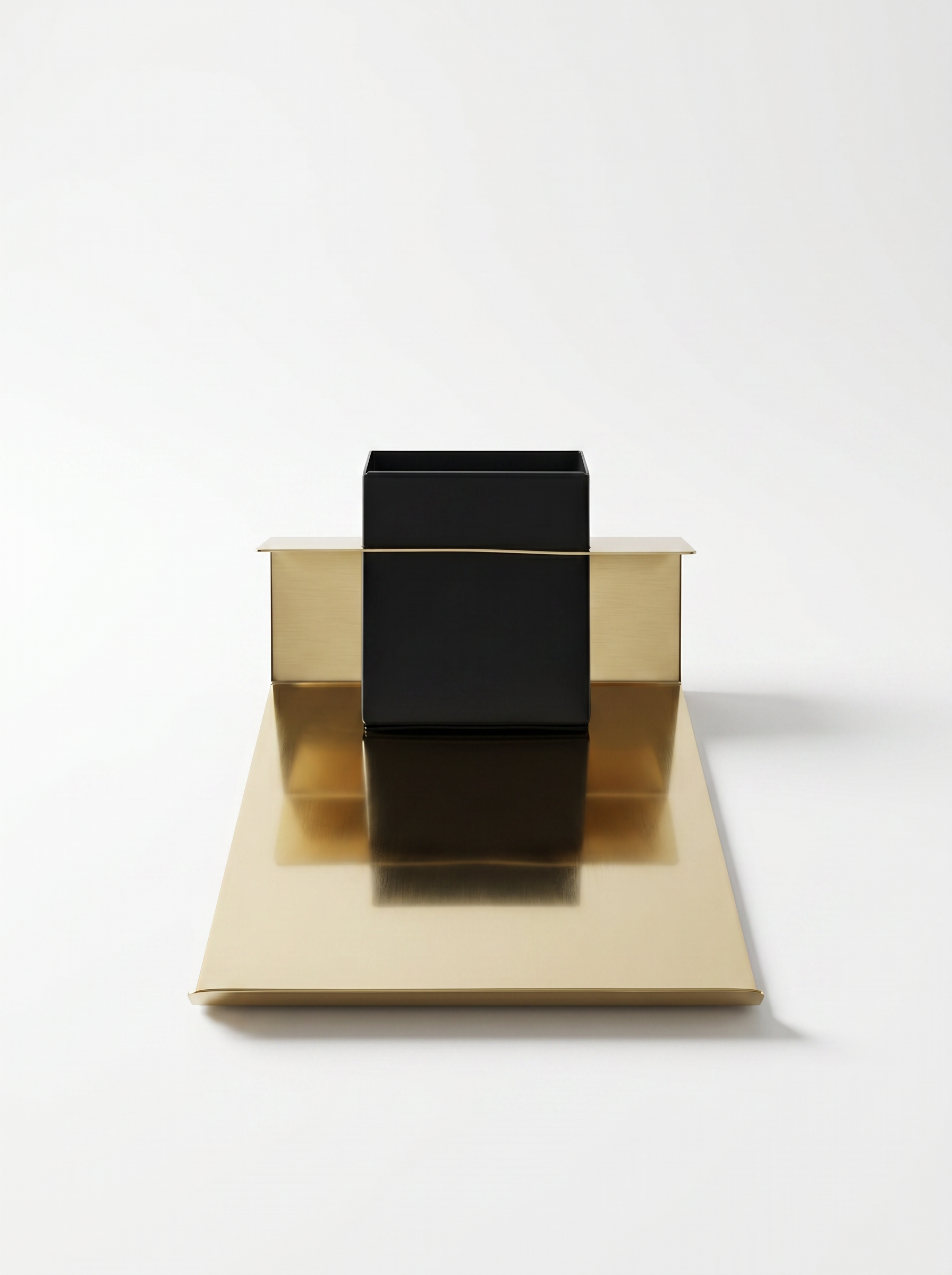 Gold and black geometric sculpture on a white background