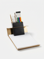Desk organizer with pens and a notebook on a white background