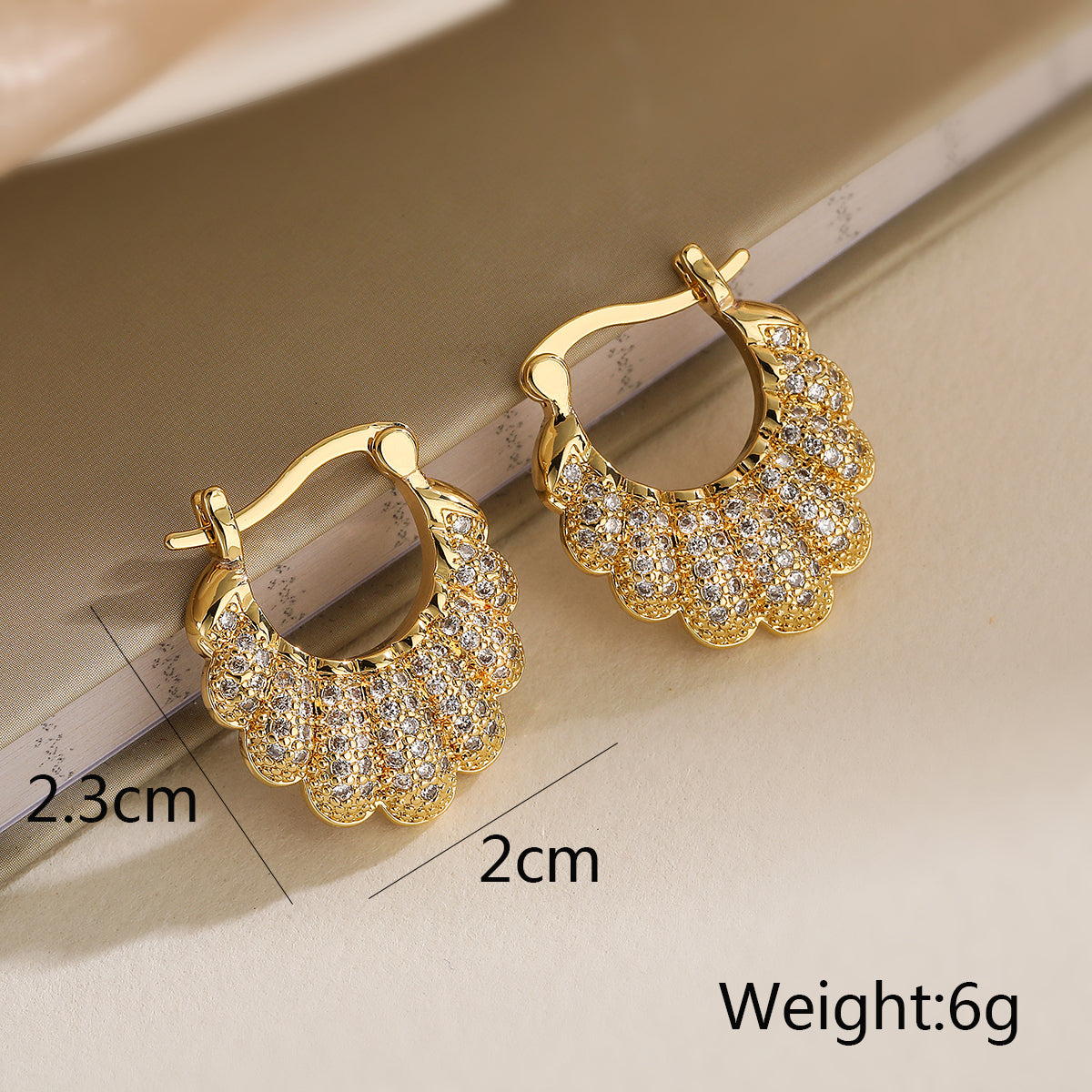 Gold hoop earrings with diamond-like stones 