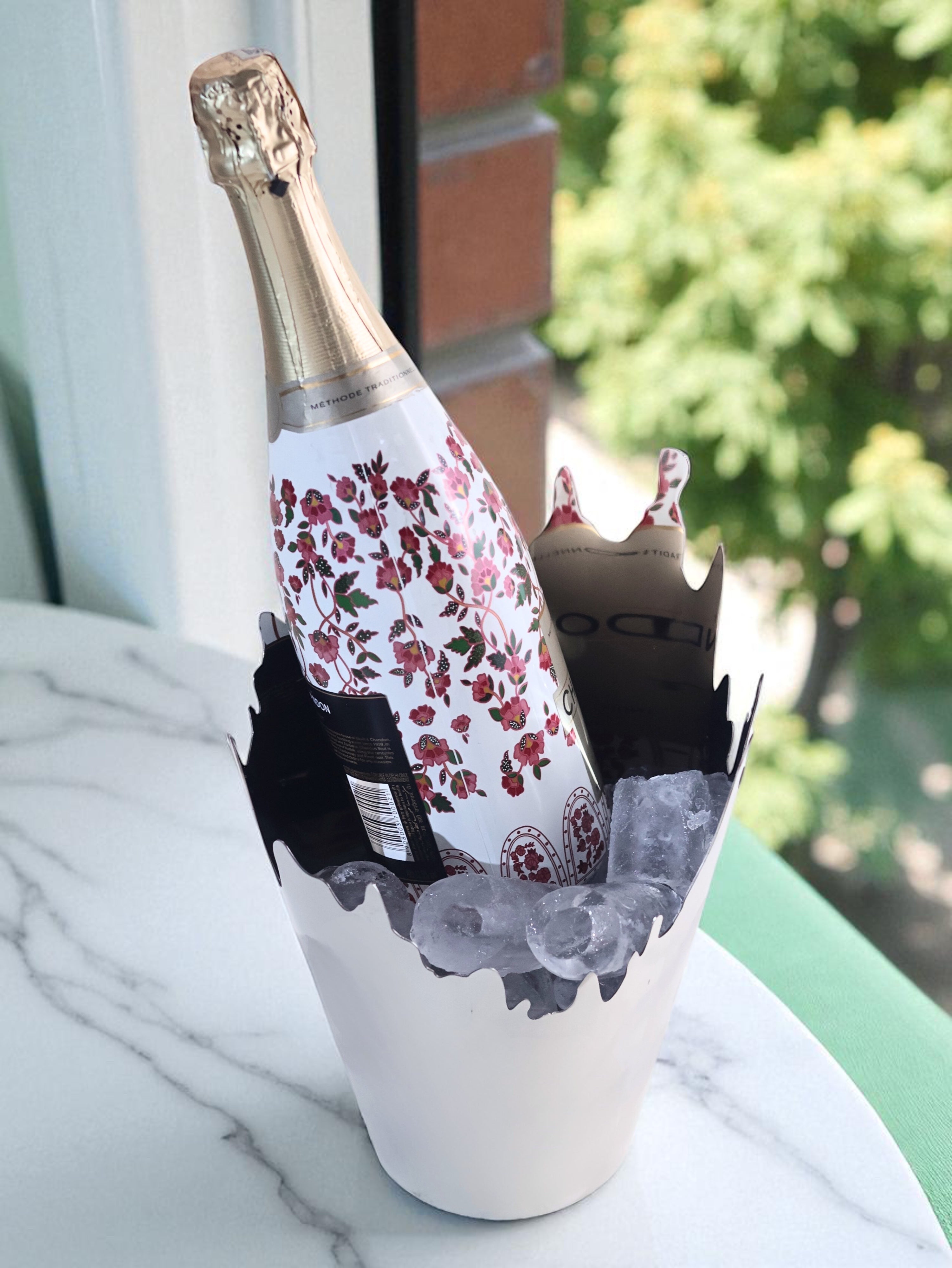 Ice bucket with ice and champagne bottle