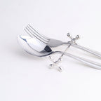 Silver spoon rest with spoon and fork