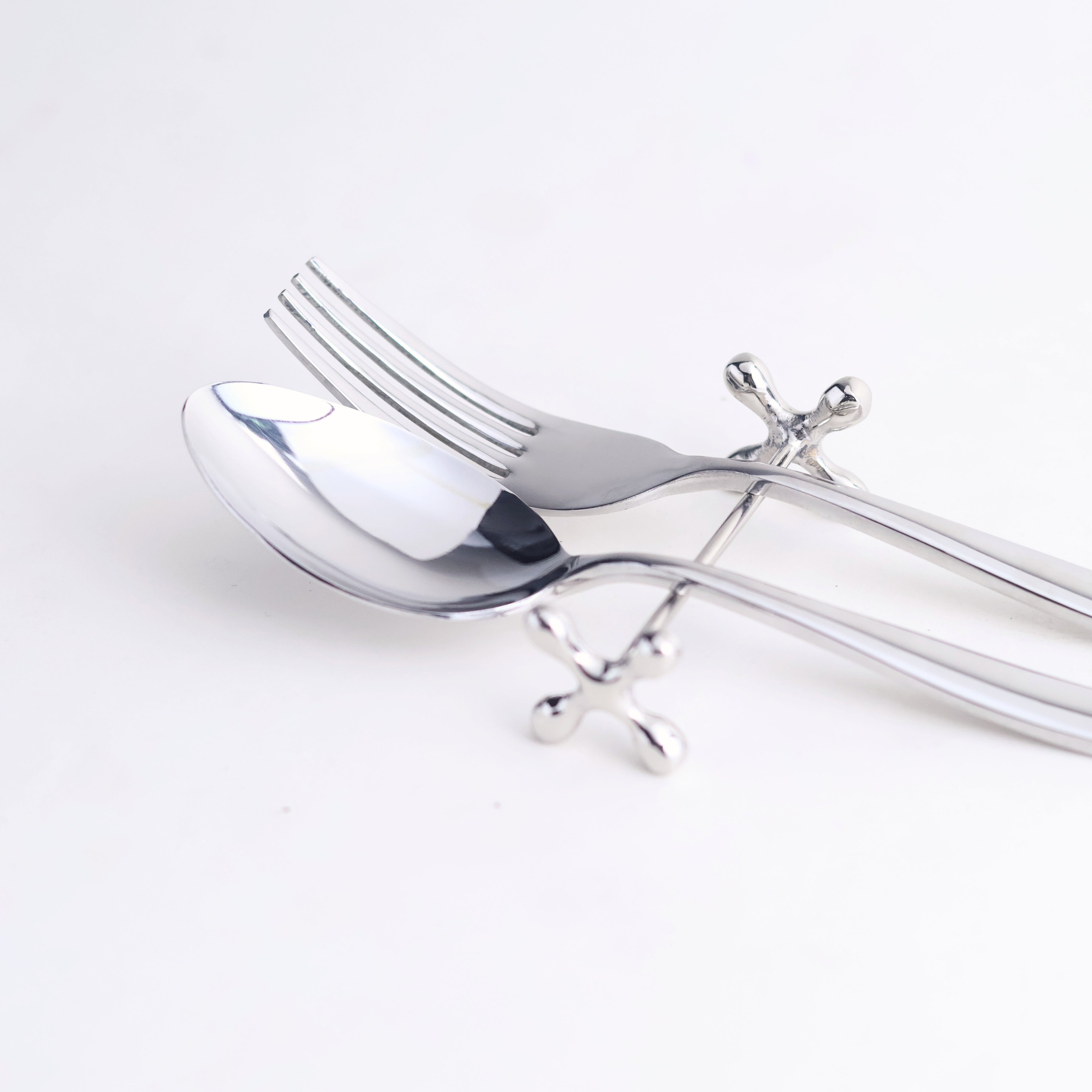 Silver spoon rest with spoon and fork