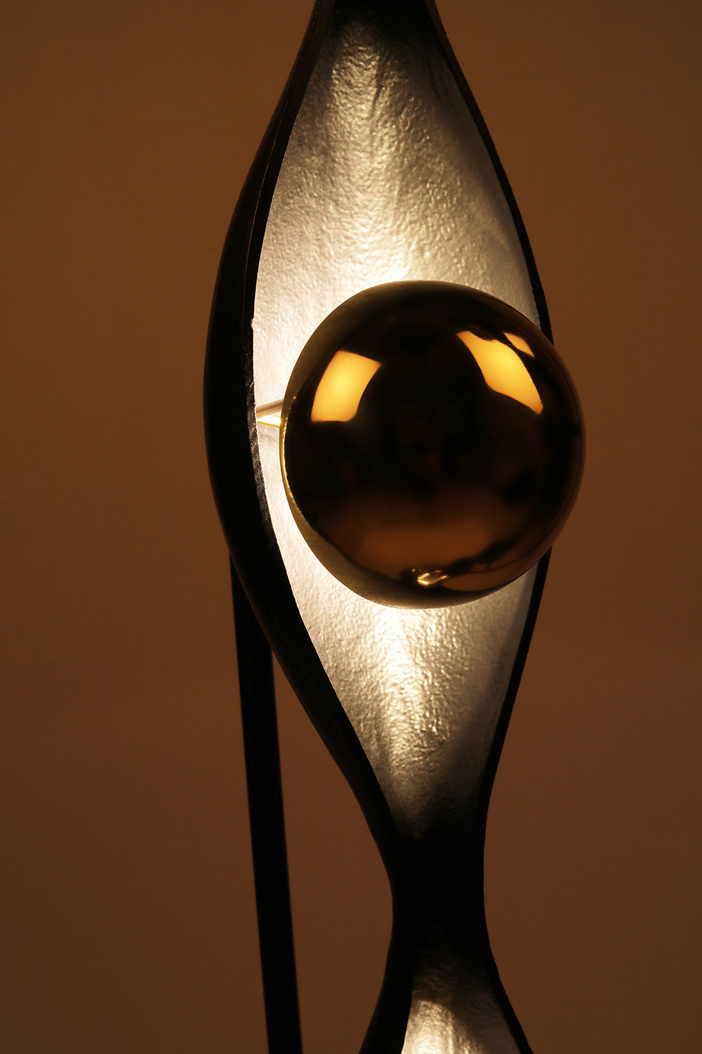 Decorative lamp with a reflective surface on a brown background