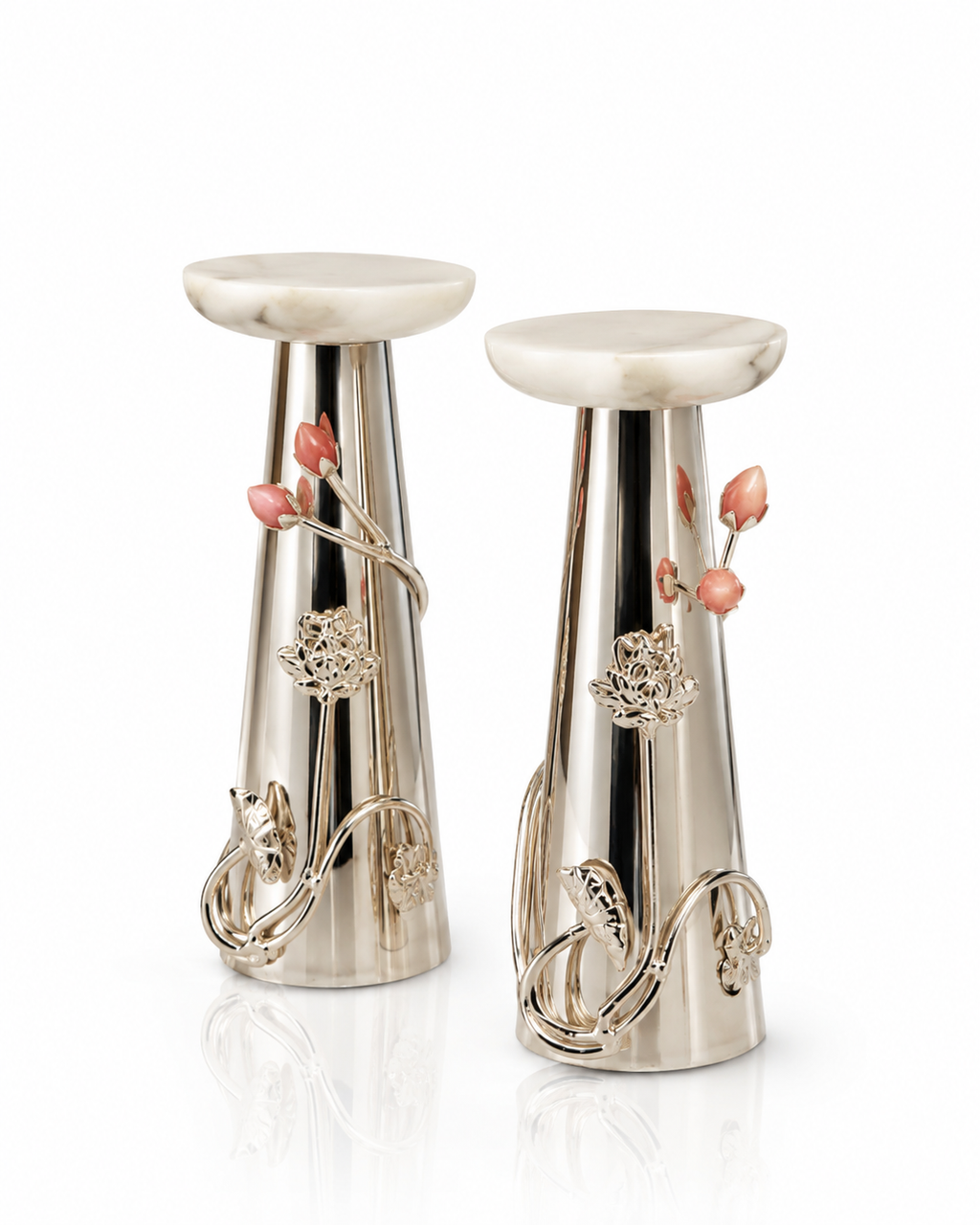 A pair of elegant silver-toned metal & marble candle holders  and delicate pink floral accents, set against a clean white background.