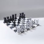Black and white chessboard with chess pieces on a gray background