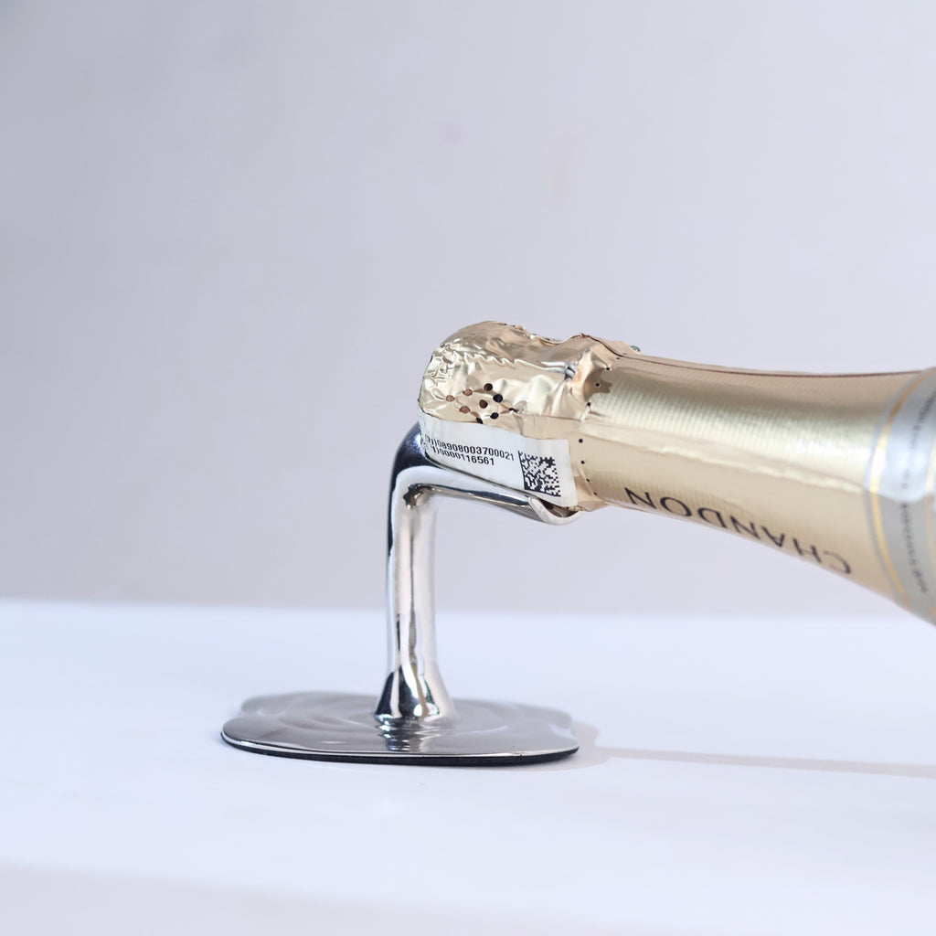 champagne bottle on a silver wine rest