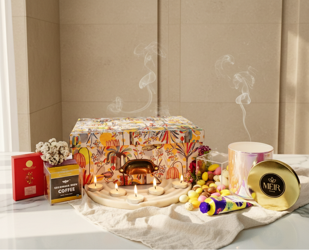 Decorative setup with candles, a box, and a candy bar on a surface.